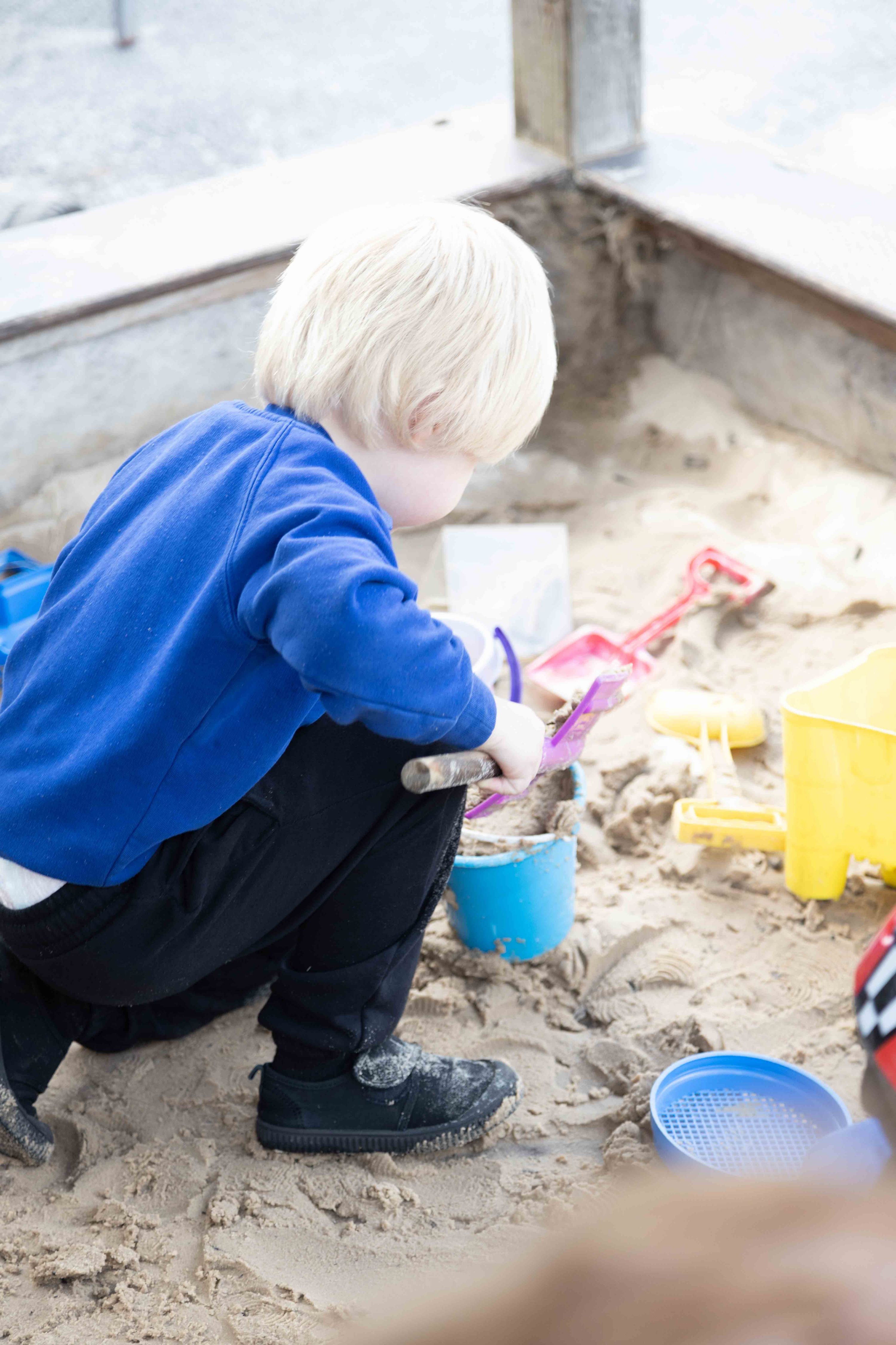 child playing in the sand